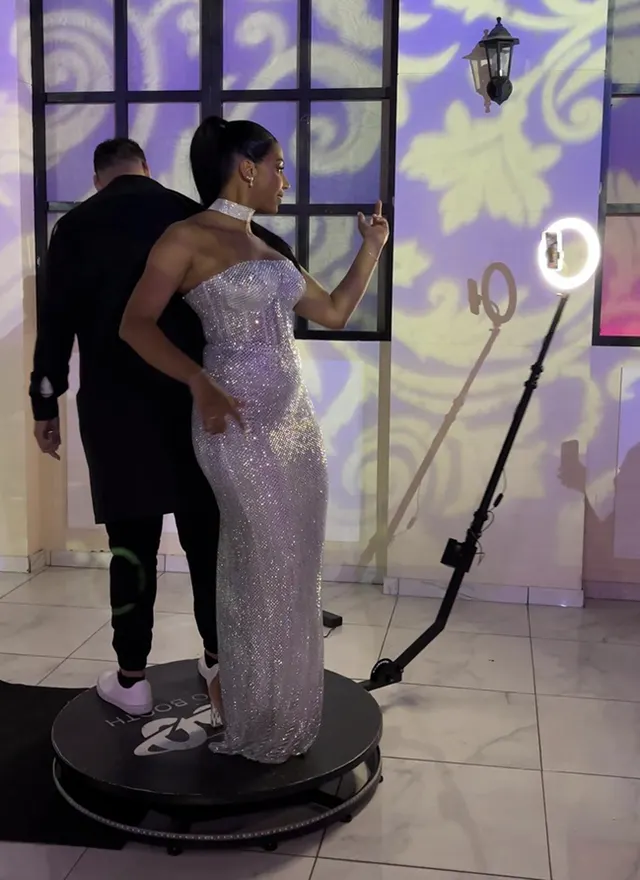 Un couple pose sur la plateforme du videobooth 360° pendant une soirée d'anniversaire
